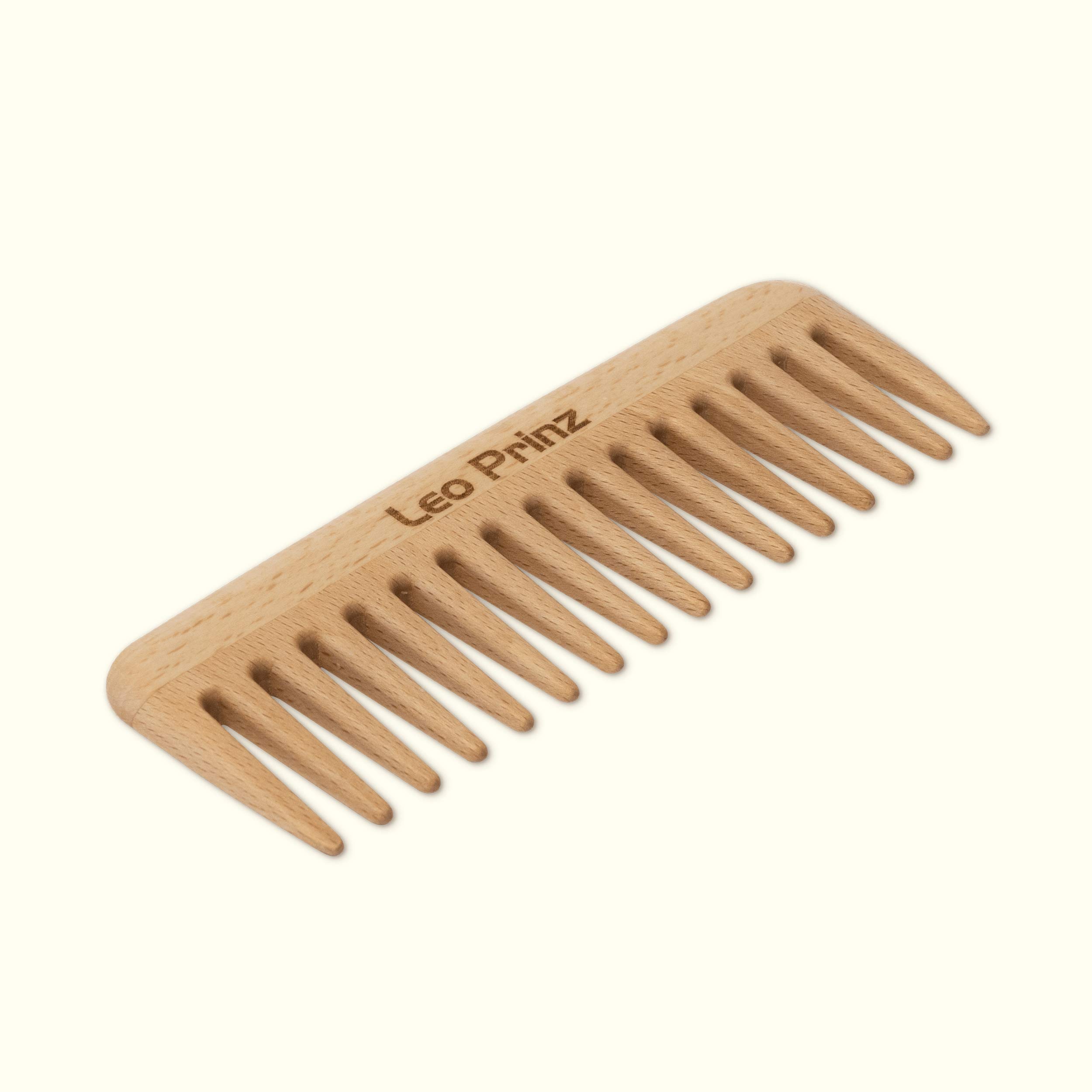 Detangling comb made from natural wood, featuring fine teeth for gentle hair grooming and styling.