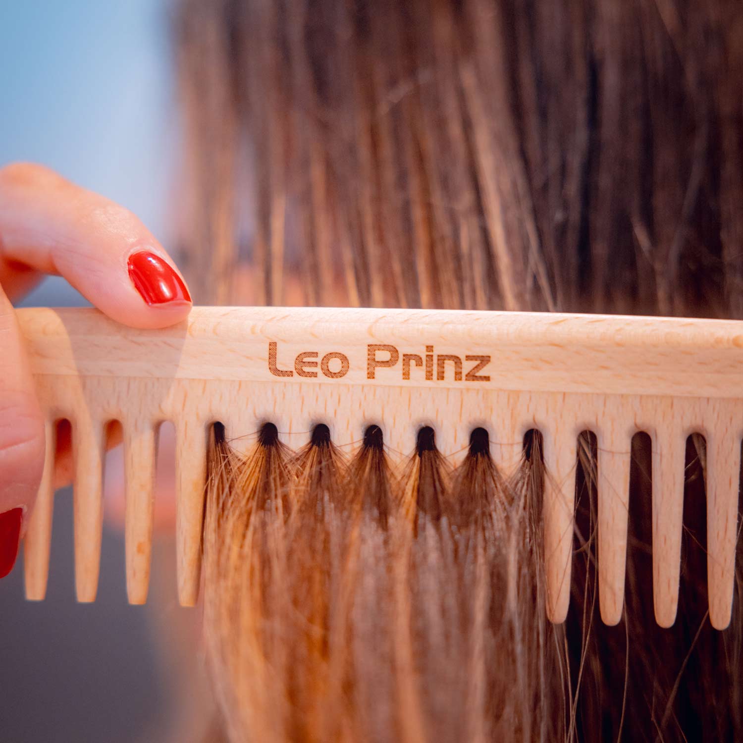 Detangling comb by Leo Prinz being used on hair, showcasing its high-quality craftsmanship and effective detangling design.