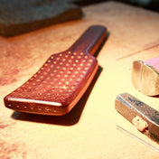 Natural hair brush with handcrafted bristles, designed for shiny hair and effective styling.