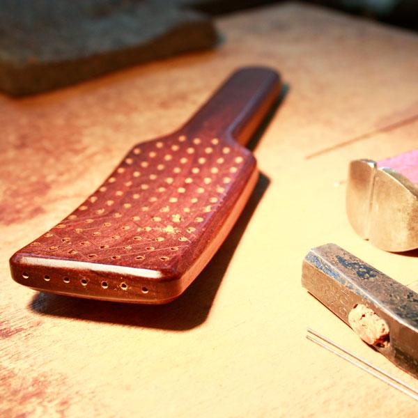 Natural hair brush with handcrafted bristles, designed for shiny hair and effective styling.
